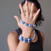 sheila of satin crystals with hand up wearing angelite and lapis stretch bracelets