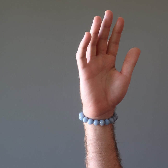 male hand wearing lapis angelite bracelet