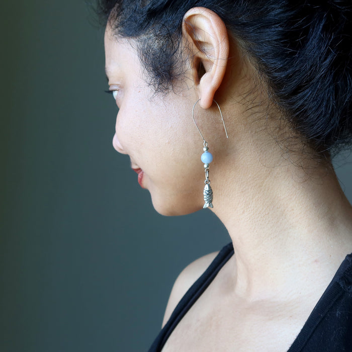 sheila of satin crystals wearing blue angelite fish earrings
