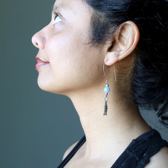 sheila of satin crystals wearing blue angelite fish earrings