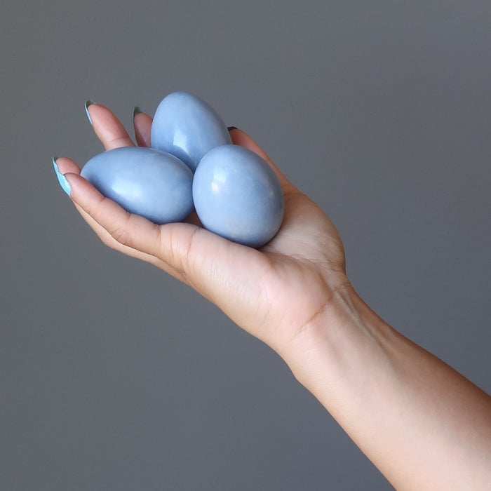 hand holding 3 angelite eggs 