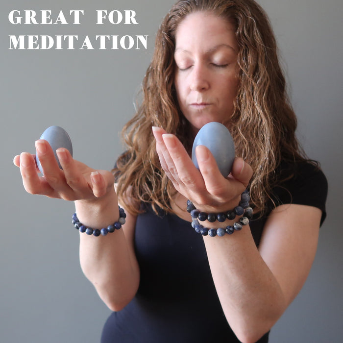 female holding angelite eggs for meditation