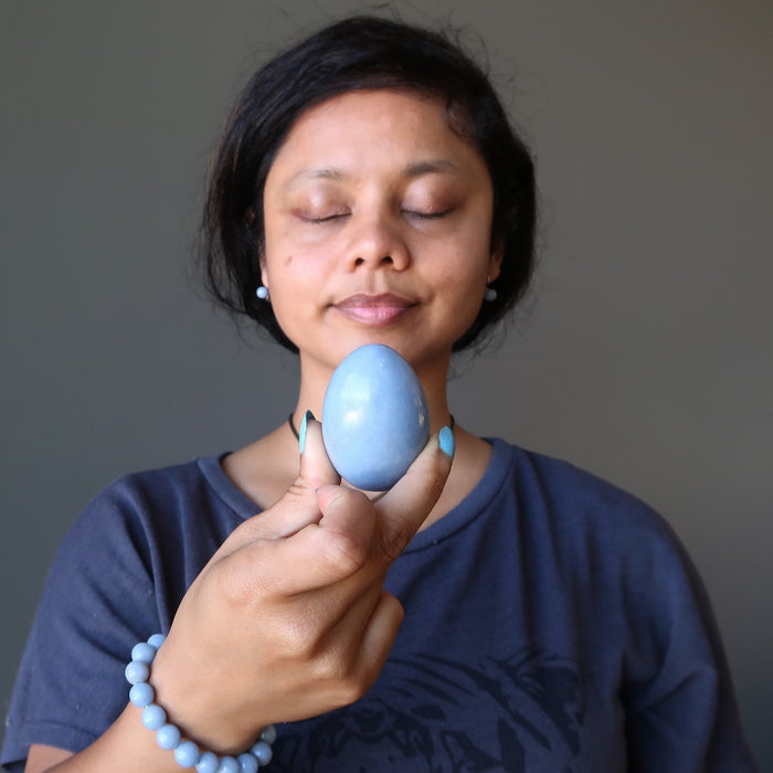 female holding angelite egg for meditation