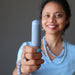 sheila of satin crystals holding blue angelite tapered massage wand