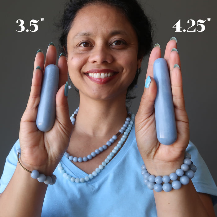 sheila of satin crystals holding two blue angelite tapered massage wands in her palms to show size difference