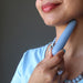 sheila of satin crystals using a blue angelite tapered massage wand at her neck