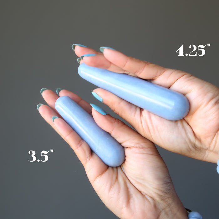hands holding two angelite massage wands showing the size differences