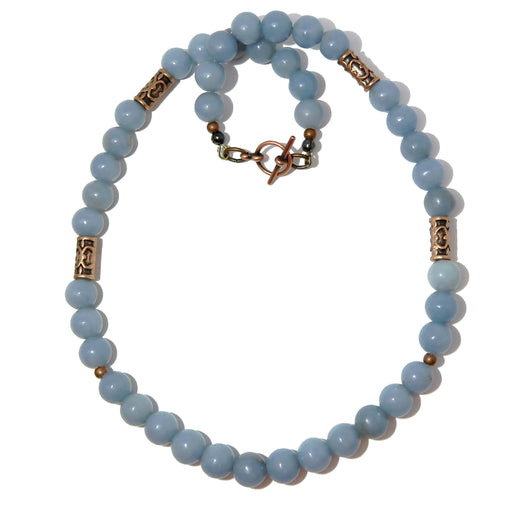 blue angelite beads with antique brass accent beads on a necklace secured with a toggle clasp