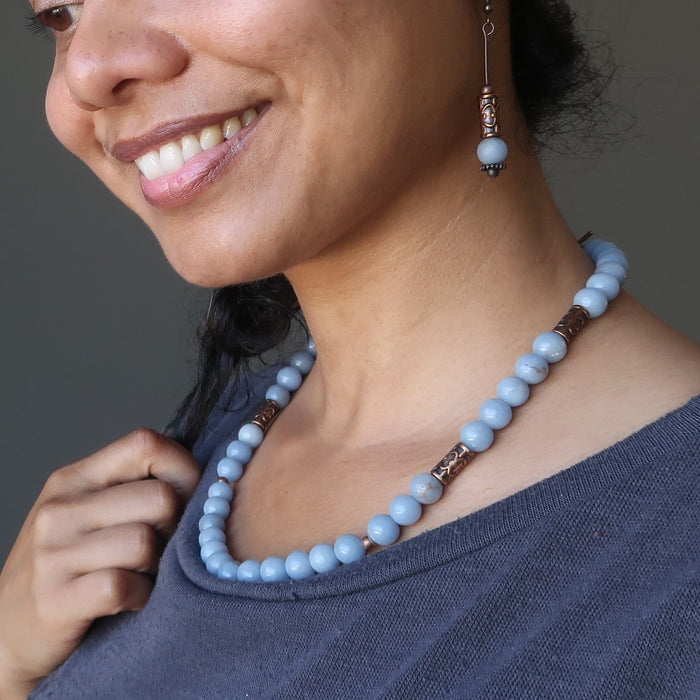 woman wearing a beaded angelite necklace and earrings
