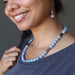 woman wearing a beaded angelite necklace and earrings