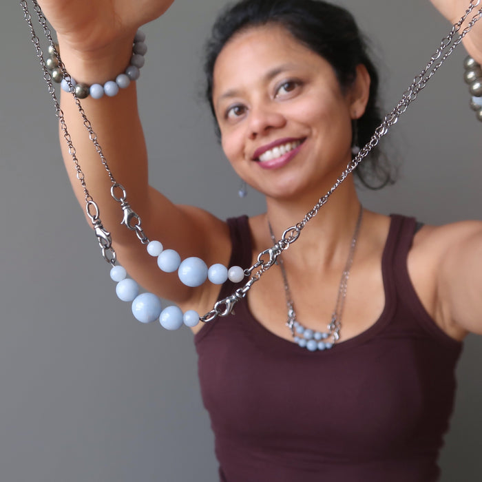 sheila of satin crytals holding angelite necklaces