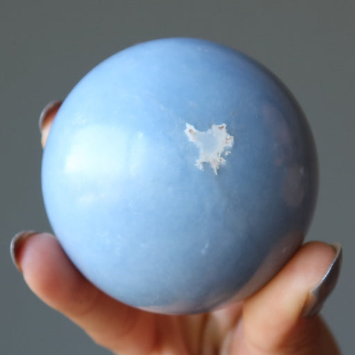 blue angelite sphere showing organite white fleck