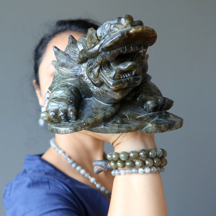sheila of satin crystals holding a big labradorite dragon turtle carving 