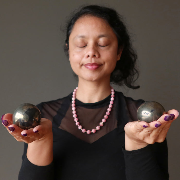 sheila of satin crystals meditating two apache gold spheres in her palms