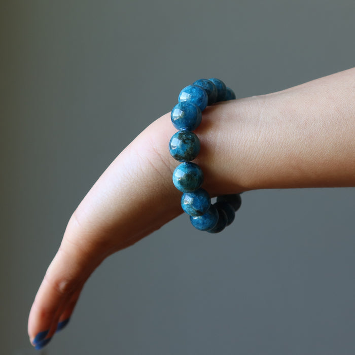 hand wearing  blue apatite gemstone stretch bracelet