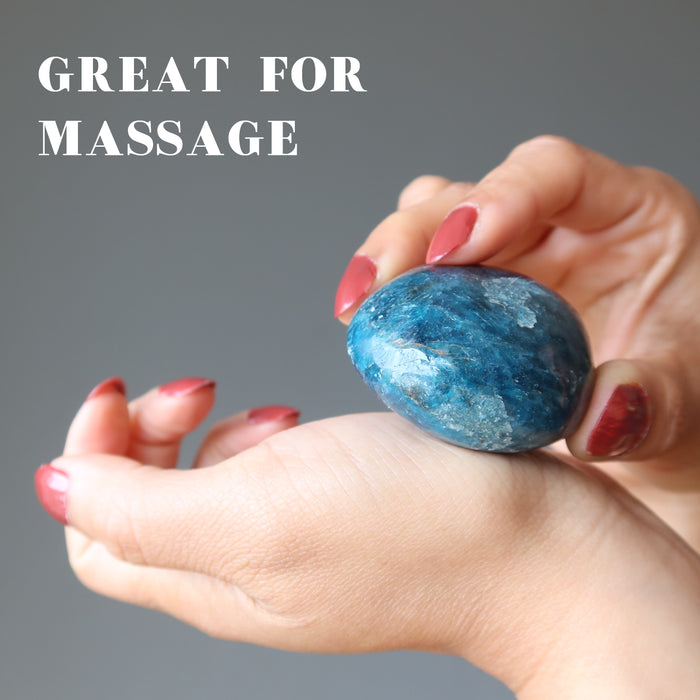 hand holding rocky blue apatite palm stone for massage