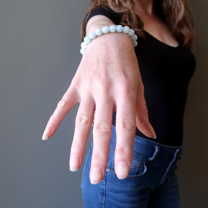 female hand modeling aquamarine bracelet+