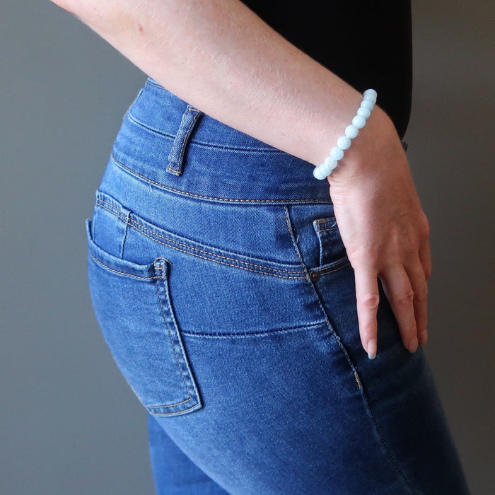 female hand on hip modeling aquamarine bracelet