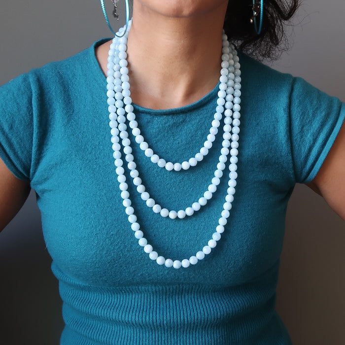 female wearing 3 blue aquamarine necklaces