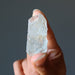 holding one raw aquamarine gemstone