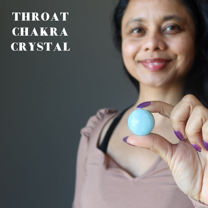 woman with blue aquamarine sphere at her throat chakra