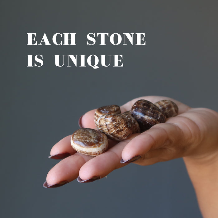 hand holding Aragonite Tumbled Stones