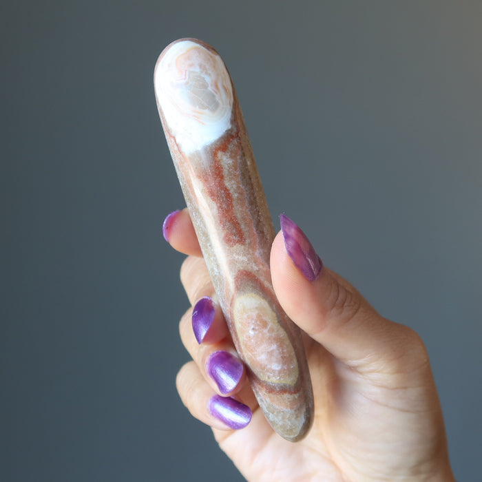 hand holding aragonite massage wand