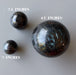 three arfvedsonite spheres to show varying sizes