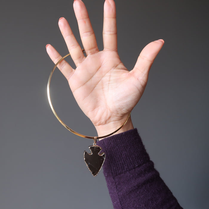 hand holding smoky quartz arrowhead necklace