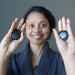 sheila of satin crystals holding Set of two round Arfvedsonite Smooth Stones