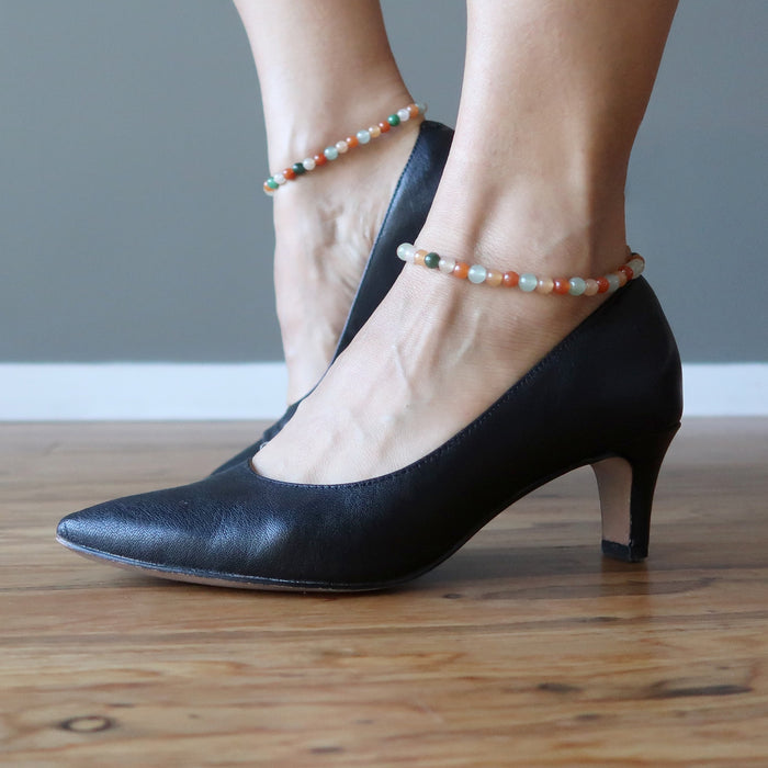feet in black heels wearing multi-colored aventurine anklets