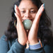 sheila of satin crystals holding a green aventurine crystal ball in between hands