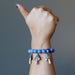 hand making a thumbs up wearing blue aventurine mushroom stretch bracelet