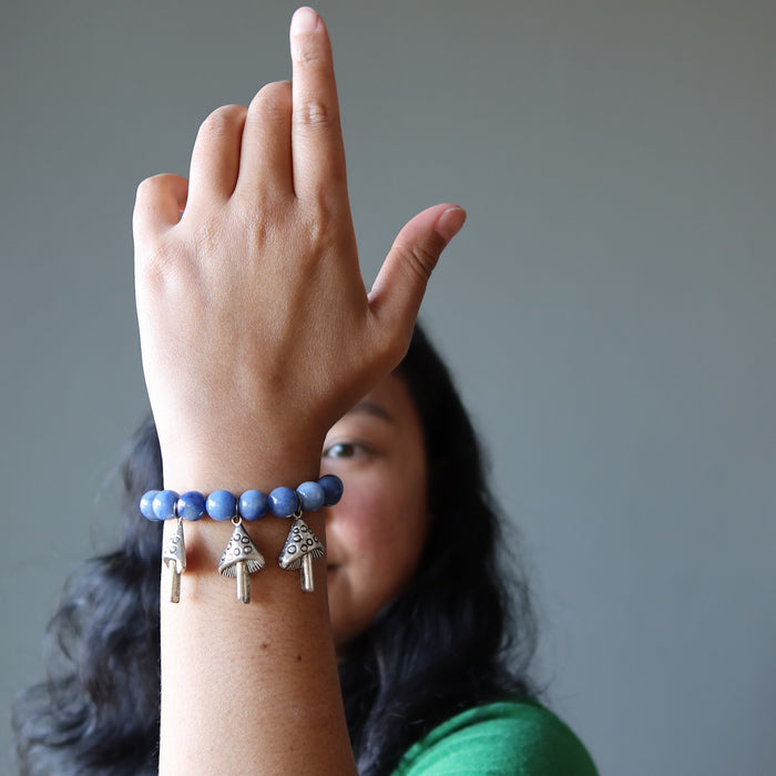 jessica of satin crystals with hand up admiring her blue aventurine mushroom stretch bracelet