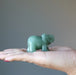 green aventurine elephant in hand