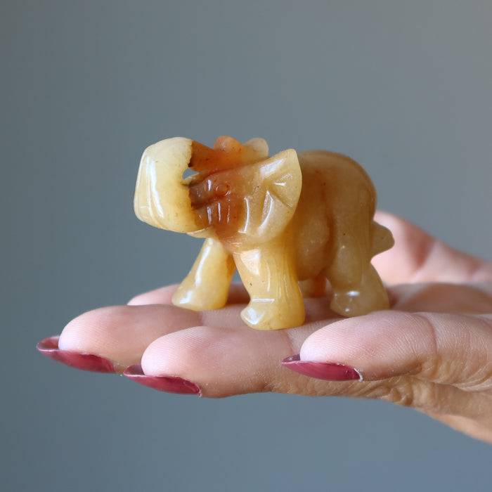 Golden Aventurine Elephant Figurine on model palm