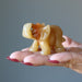 Golden Aventurine Elephant Figurine on model palm