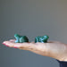 two Green Aventurine Frog Statues on the palm