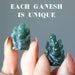 holding aventurine ganesh on each hand showing uniqueness
