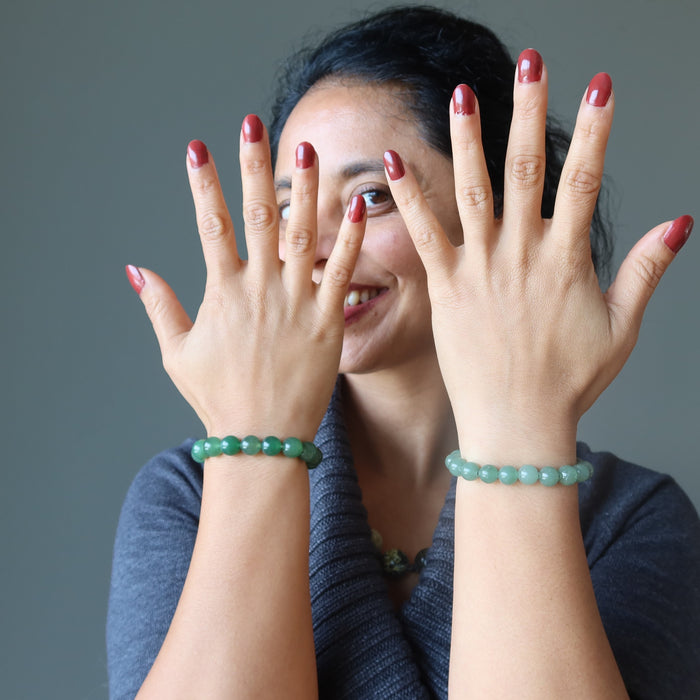 female modeling two green aventurine beaded stretch bracelets