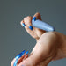 hand holding blue aventurine tapered massage wand to wrist