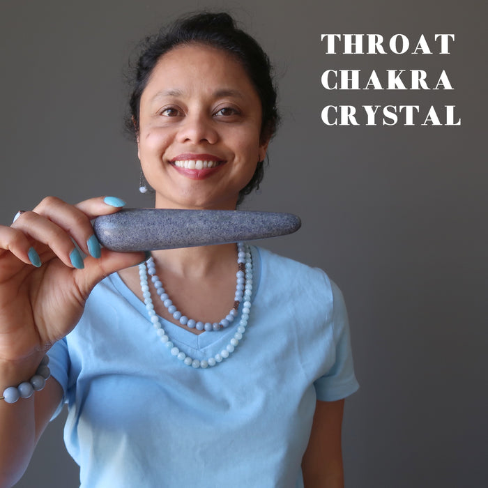 sheila of satin crystals holding blue aventurine tapered massage wand at throat chakra