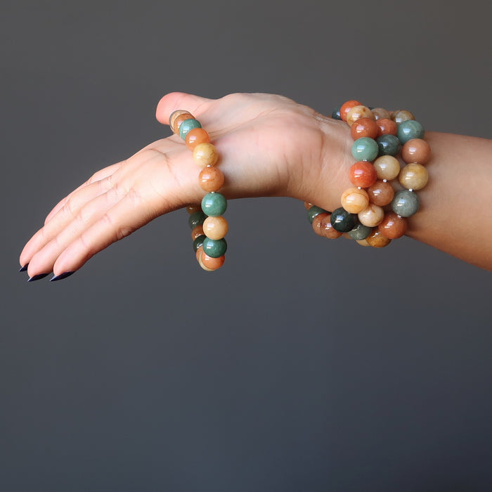 hand wearing 4 multi colored aventurine stretch bracelets
