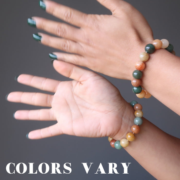 two hands wearing multi colored aventurine stretch bracelets showing colors vary