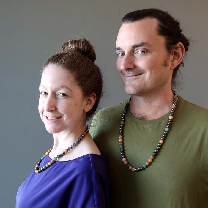 man and woman both wearing aventurine necklaces