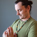man in meditation wearing an aventurine medley necklace