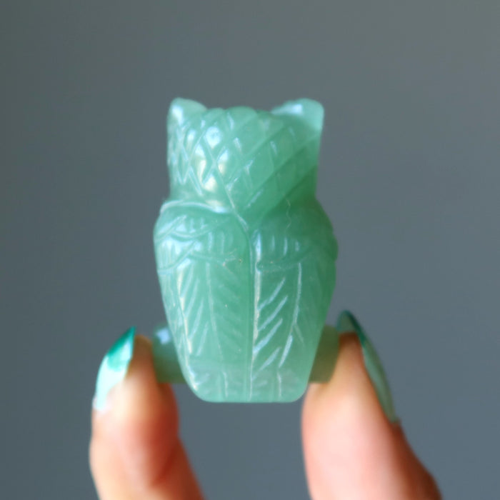 finger tips holding showing Green Aventurine Owl