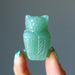 finger tips holding showing Green Aventurine Owl