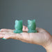 displaying two Green Aventurine Owls on the palm