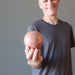 male holding pink aventurine sphere